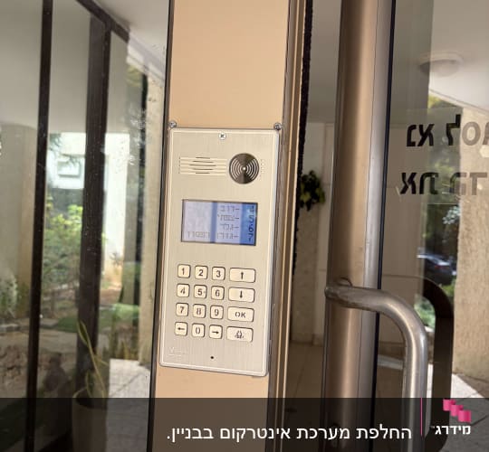 פאנל אינטרקום וקודן דיגיטלי מותקן בדלת כניסה לבניין משותף
